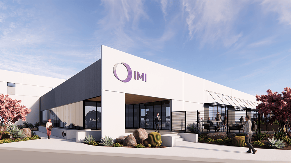 Render of IMI's California site, showcasing the modern building design with a welcoming front entrance and outdoor seating area.
