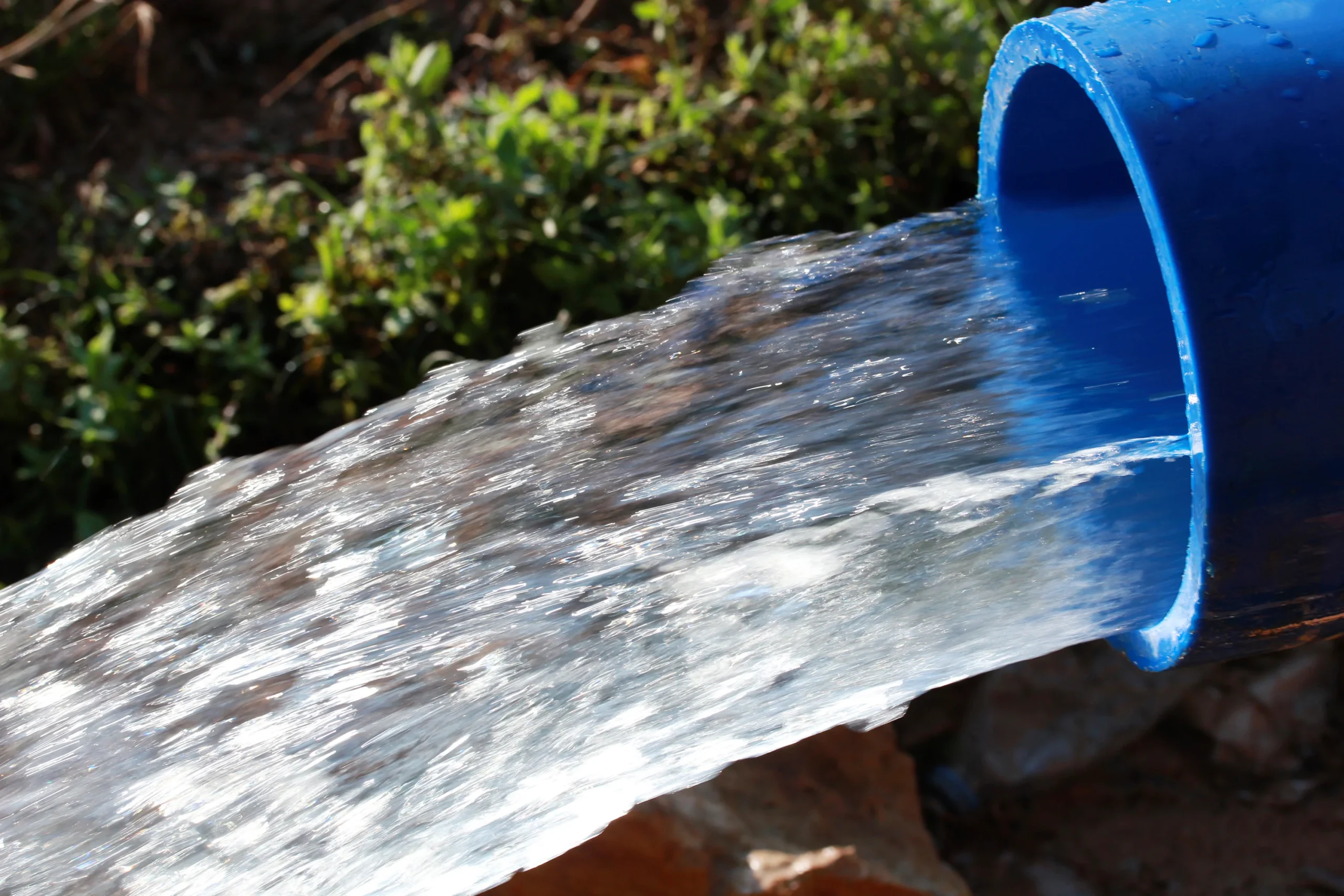 Water pipe pumping out water: Symbol of global water industry's commitment to provide safe, accessible, and sustainable water resources worldwide
